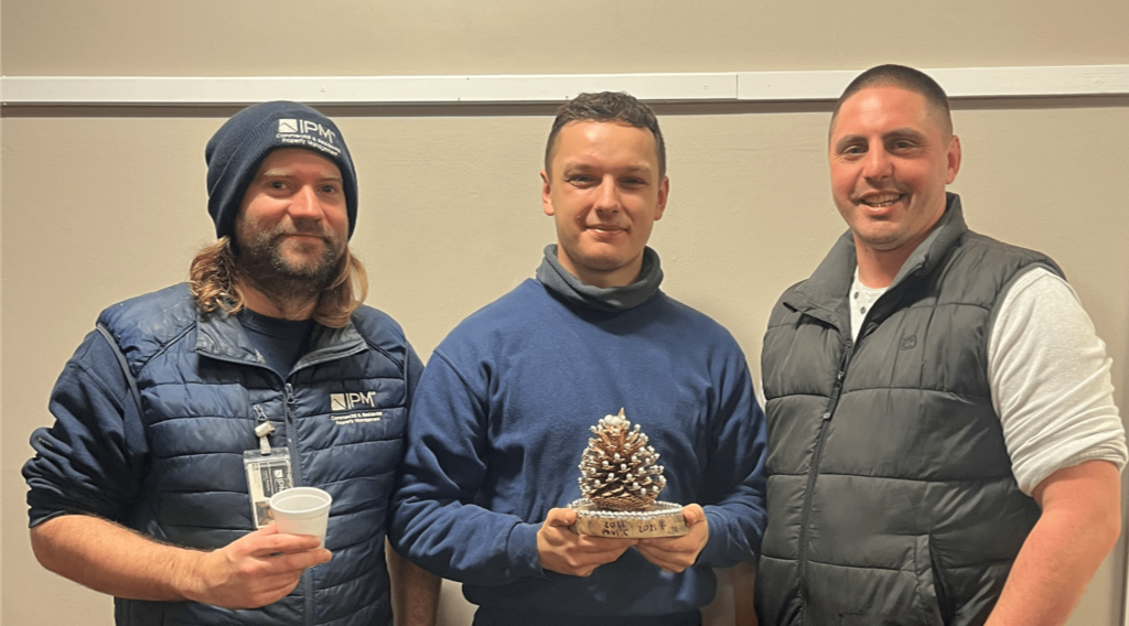 Neil the winner of the golden pinecone trophy with the landscaping team