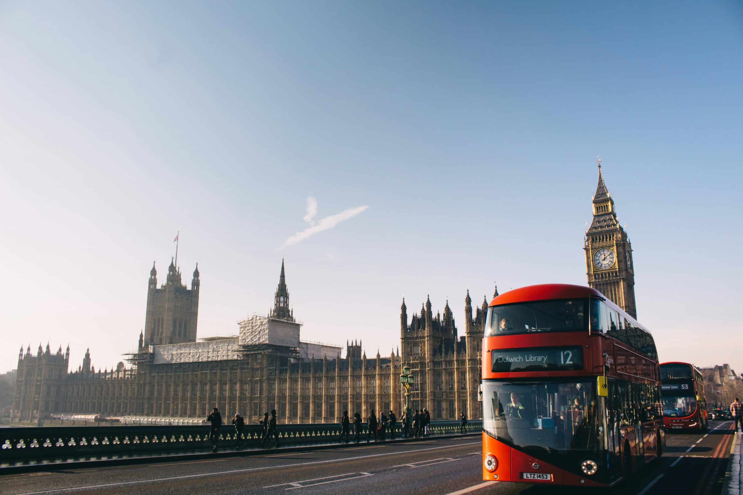 London photo, over london bridge, with classic red bus and big ben in the background