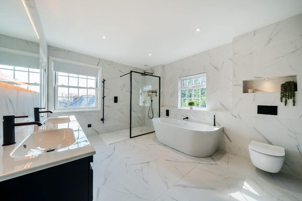 large white bathroom with shower, tub, sink and toilet