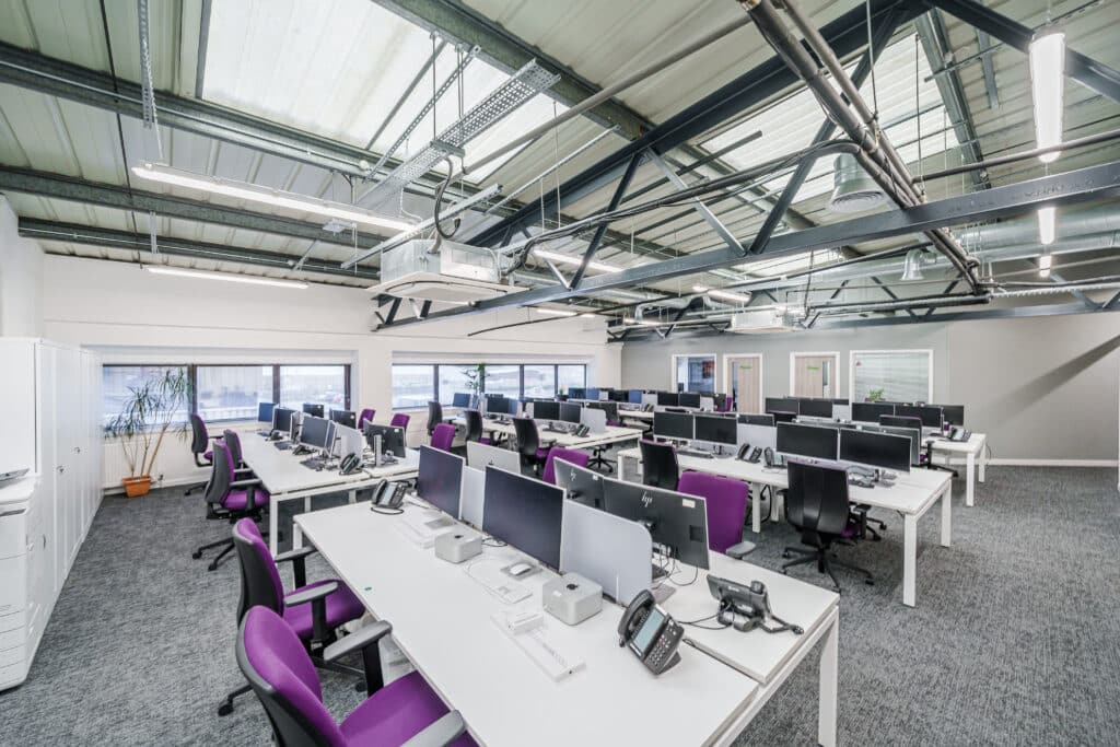 newly renovated commercial office in tunbrdge wells, withislands of computed, chairs, desks.