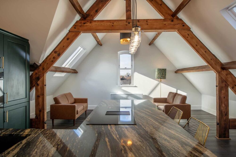 exposed beams in a converted buiding, showing warm lighting, a modern renovation and cosy interior. a development based in York 